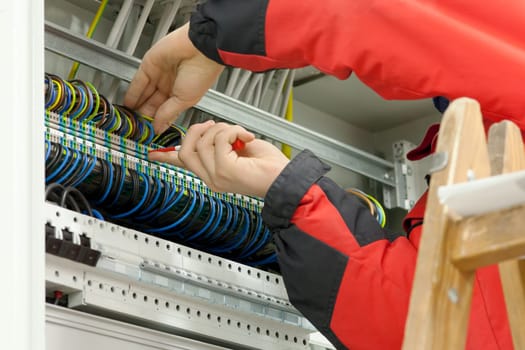 Electrician,craftsman working on cables in the control box