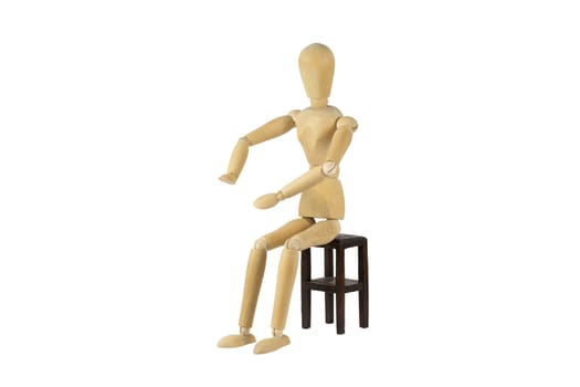 A wooden female doll is pushing something away