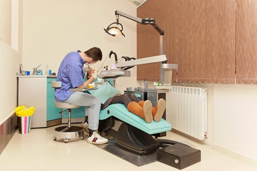 Dentist office interior with patient in the chair