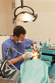 Blonde girl in chair at dentist office
