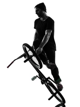 one caucasian man exercising bmx acrobatic figure in silhouette studio isolated on white background