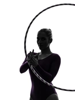 one caucasian woman exercising Rhythmic Gymnastics hula hoop  in silhouette studio isolated on white background