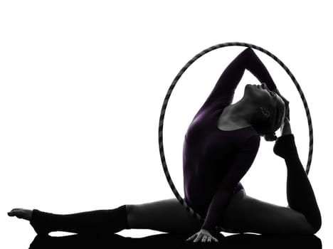 one caucasian woman exercising Rhythmic Gymnastics hula hoop  in silhouette studio isolated on white background