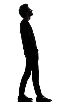 one african handsome young man standing  looking up smiling  in silhouette studio isolated on white background