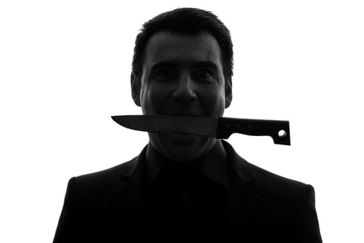 one caucasian man biting knife in silhouette studio isolated on white background