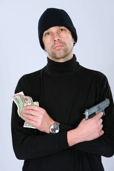 man in black outfit with money and gun
