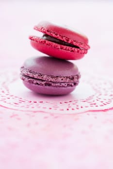 Closeup of two sweet macaroons on pink mat