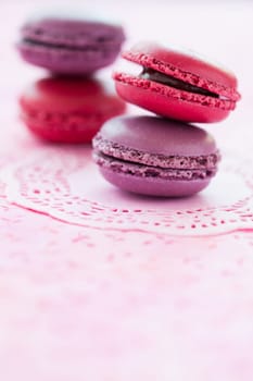 Closeup of two stacks of sweet macaroons on pink mat
