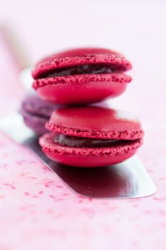 Closeup of sweet macaroons on metal cake server