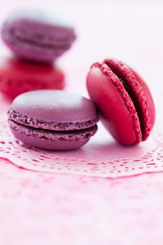 Closeup of sweet macaroons on pink mat