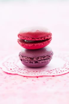 Closeup of two sweet macaroons on pink mat