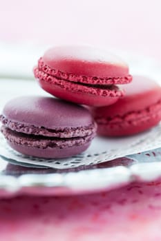 Closeup of three sweet macaroons on white decorative mat