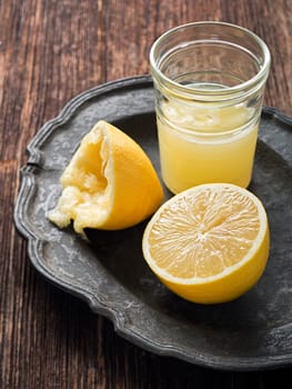 Freshly squeezed lemon on vintage plate close up
