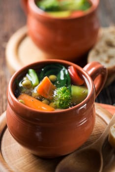 Vegetarian soup on wooden background close up