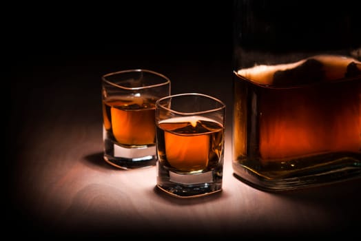 Bottle and two glasses of whiskey close up