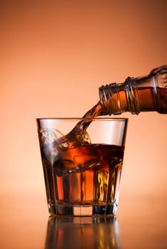 Whiskey pouring into glass close up shoot
