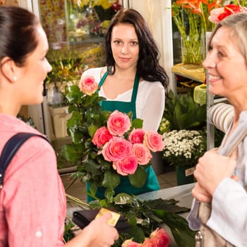 Women customers buying card flower shop pink roses florist