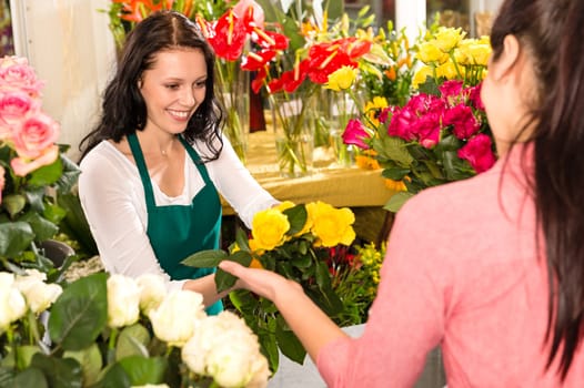 Cheerful flower shop florist customer buying yellow bouquet women