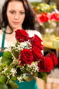 Young woman making flower bouquet florist shop roses selling