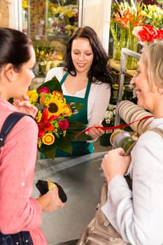 Happy women customers buying flowers sunflower bouquet shop florist