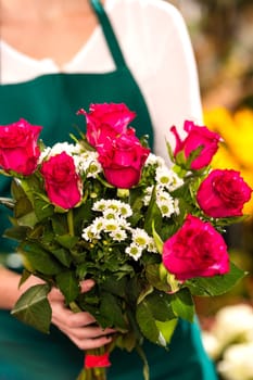 Florist woman holding red roses bouquet hands flower shop
