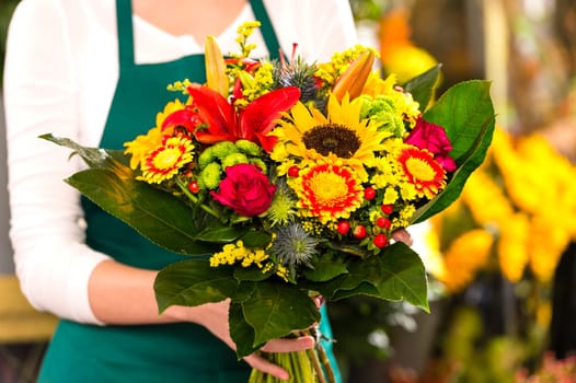 Florist holding bouquet colorful flowers shop assistant hands