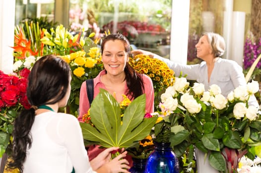 Young woman buying bouquet flower shop colorful customer