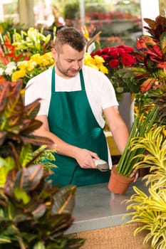 Florist man reading barcode potted plant shop market flower