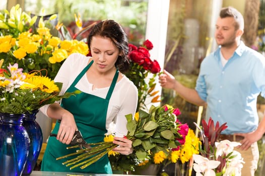 Woman florist cutting flowers shop bouquet man customer choosing