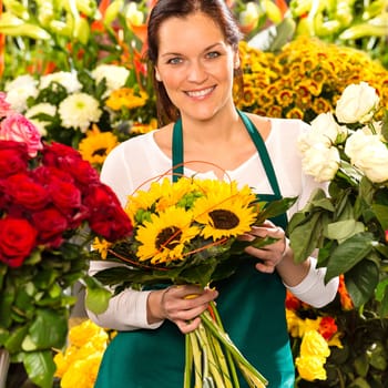 Smiling florist woman bouquet sunflowers flower shop colorful showing