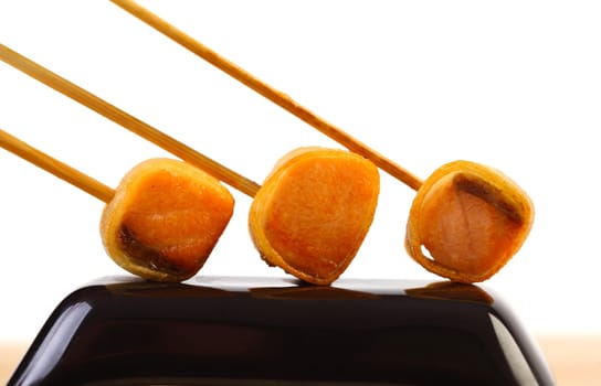 Salmon appetizers on stick on black plate