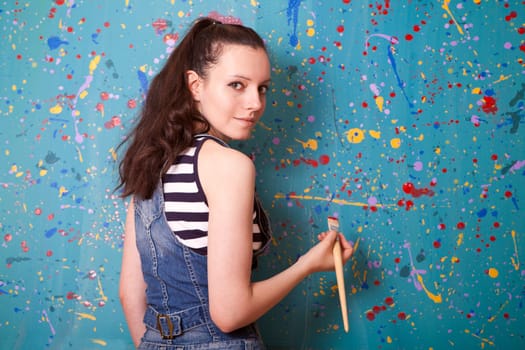 woman holding up a paintbrush