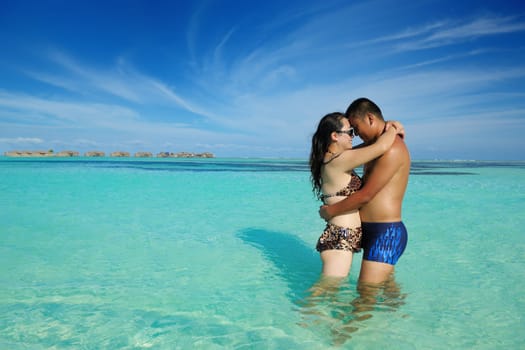 happy young asian couple enjoying summer and have on beautiful white sand beach