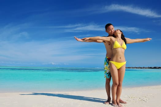 happy young asian couple enjoying summer and have on beautiful white sand beach