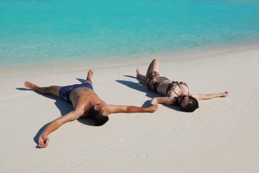 happy young asian couple enjoying summer and have on beautiful white sand beach
