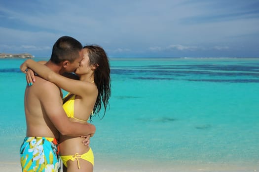 happy young asian couple enjoying summer and have on beautiful white sand beach