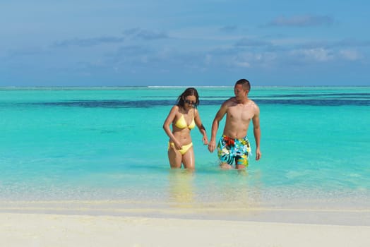 happy young asian couple enjoying summer and have on beautiful white sand beach