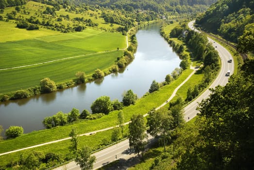 Odenwald: View of the Neckar with fields and road,intense lighting atmosphere