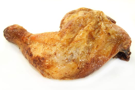 a grilled chicken thigh against a white background