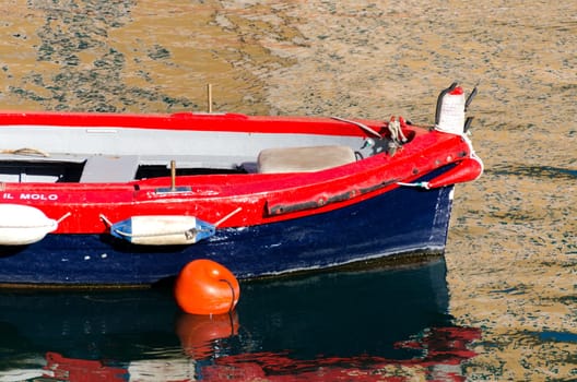 Red and blue boat in the port of Camogli Genoa