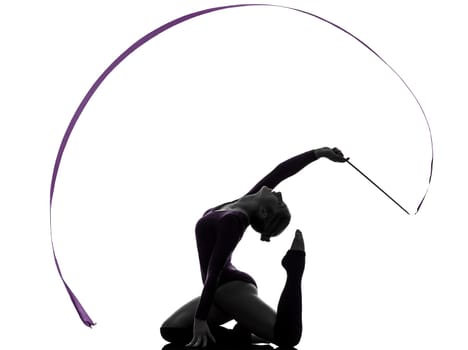 one caucasian woman exercising Rhythmic Gymnastics with ribbon  in silhouette studio isolated on white background