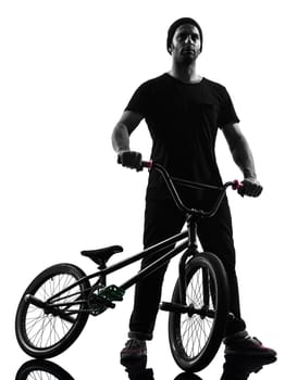 one caucasian man exercising bmx acrobatic figure in silhouette studio isolated on white background