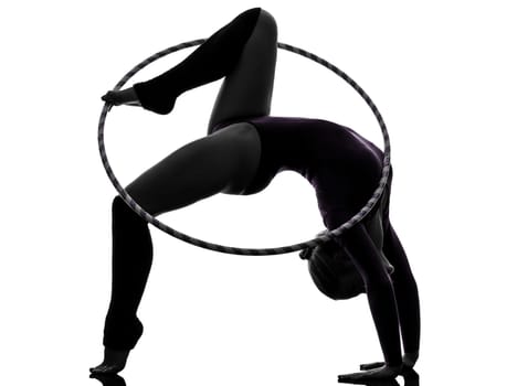one caucasian woman exercising Rhythmic Gymnastics hula hoop  in silhouette studio isolated on white background