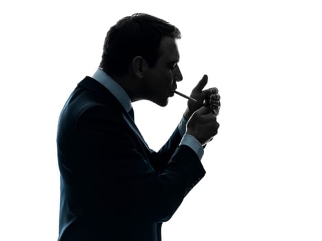 one caucasian man smoking cigarette  in silhouette studio isolated on white background
