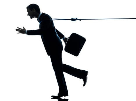 one caucasian business man catched by lasso rope  in silhouette studio isolated on white background