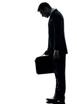 one caucasian sad business man  looking down  in silhouette studio isolated on white background