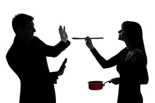 one caucasian couple man and woman tasting cooking sauce pan in studio silhouette isolated on white background