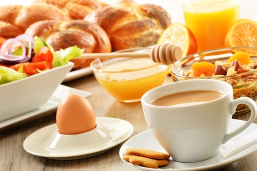Breakfast including coffee, bread, honey, orange juice, muesli and fruits