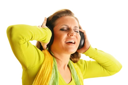 Happy young woman listening to the music in headphones isolated on white background
