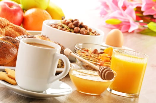 Breakfast including coffee, bread, honey, orange juice, muesli and fruits
